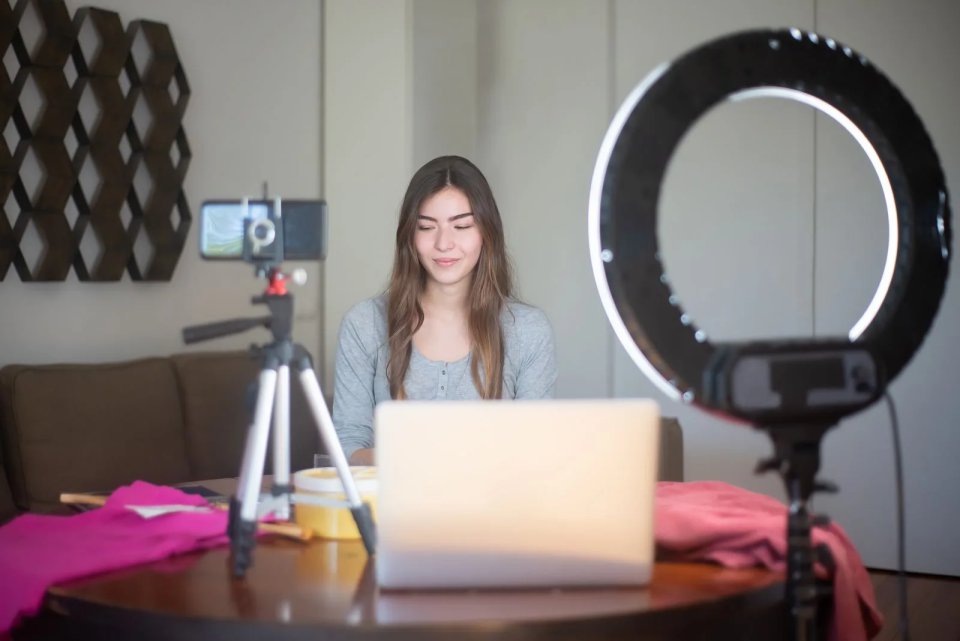 Woman vlogging with a ring light and tripod