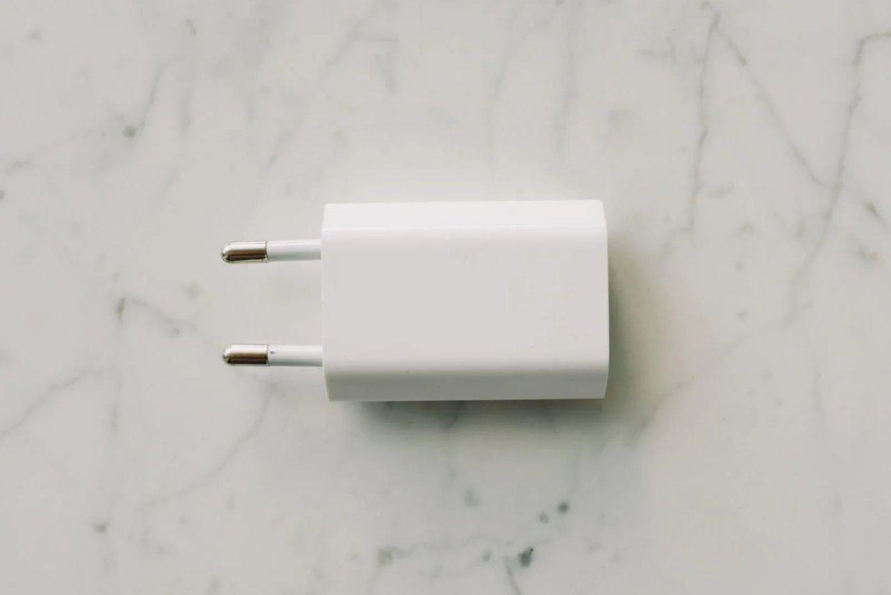 White GaN wall charger on marble