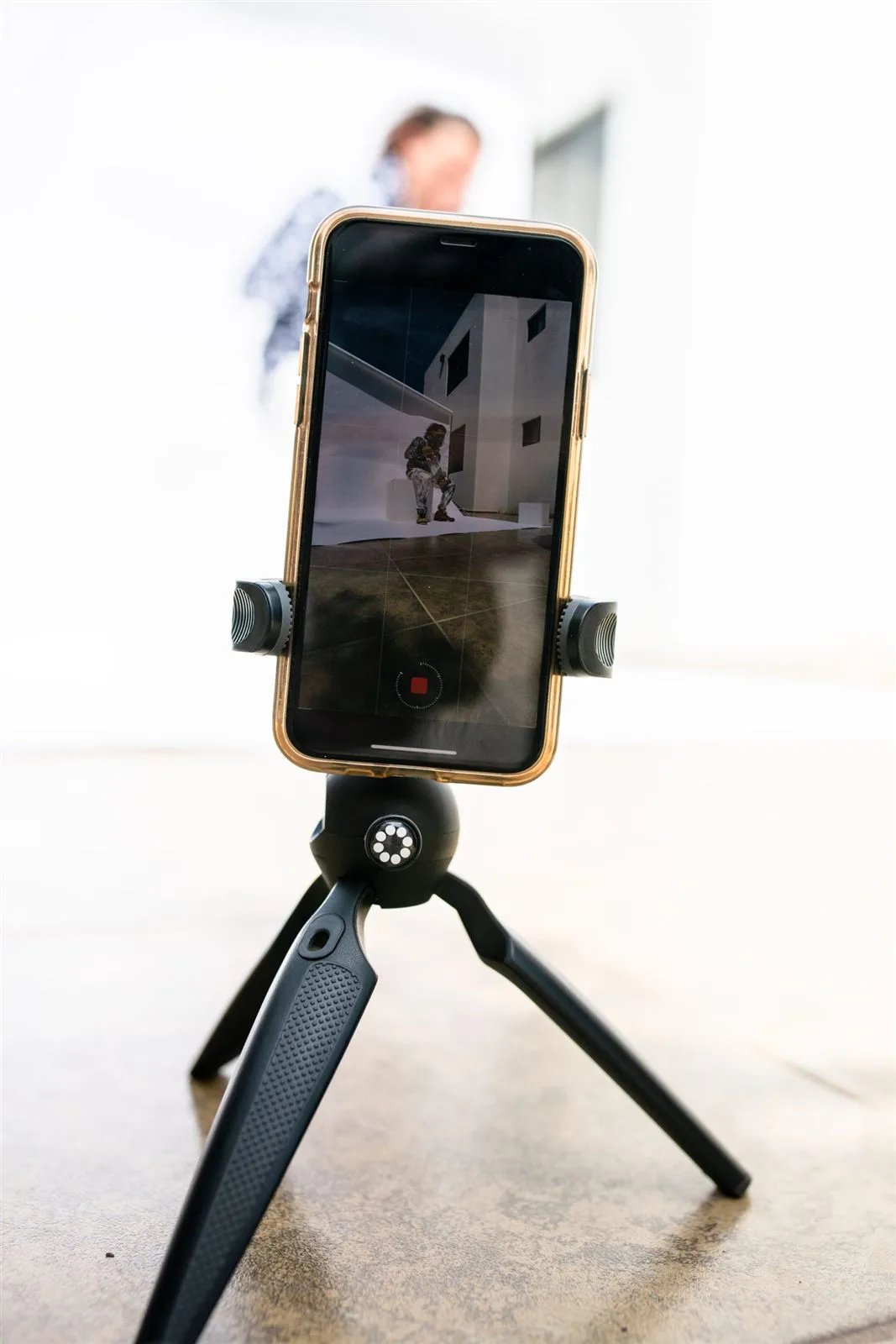 Smartphone recording on a black tripod